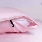 Close-up of The Lad Collective blush pink bamboo cotton blend pillowcase with branded invisible zipper, offering a sleek, secure fit and ultra-soft finish.