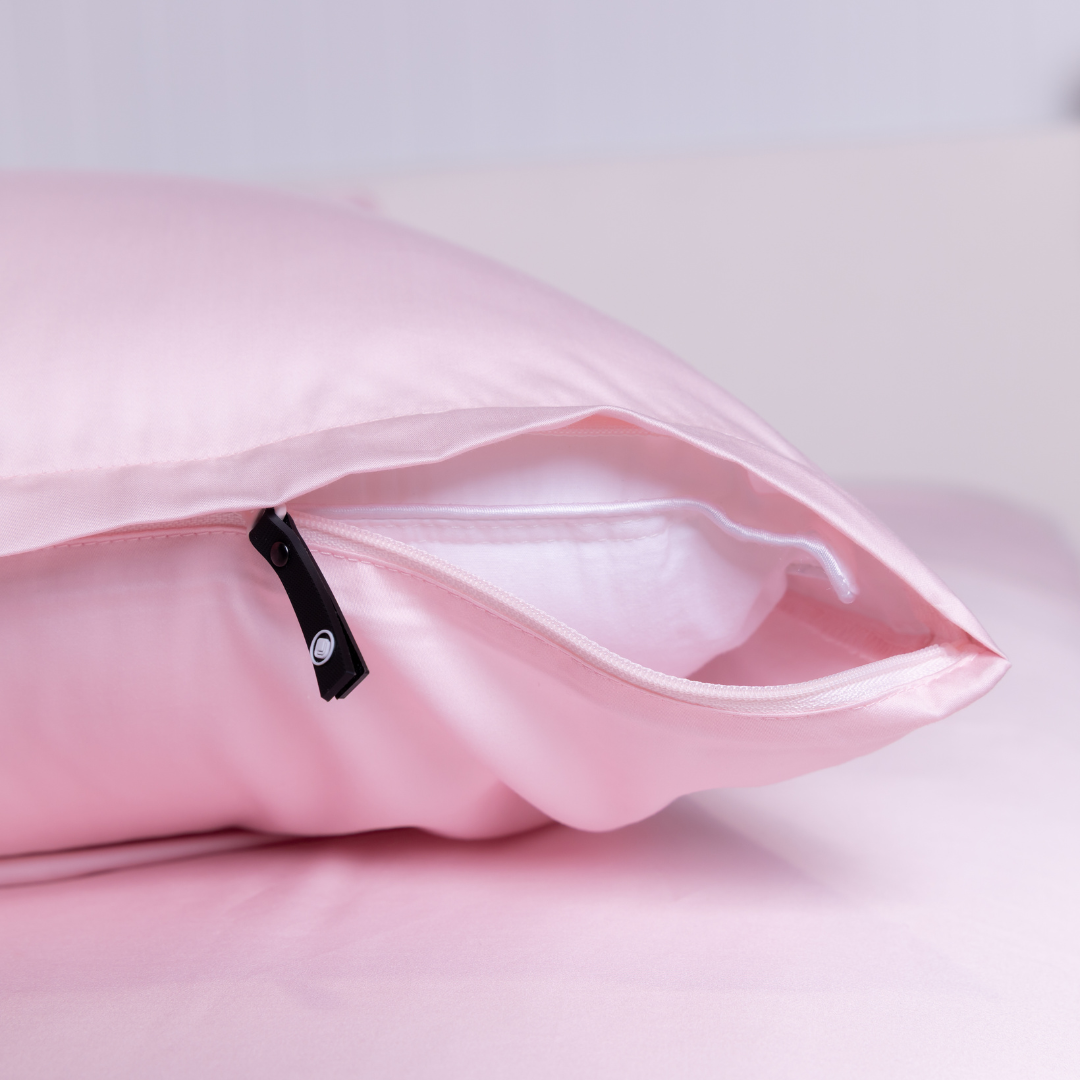 Close-up of The Lad Collective blush pink bamboo cotton blend pillowcase with branded invisible zipper, offering a sleek, secure fit and ultra-soft finish.