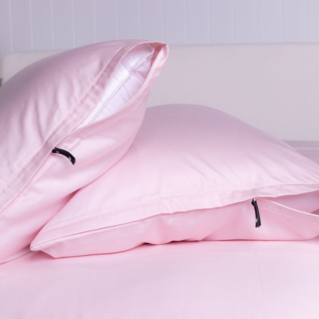 Close-up of The Lad Collective blush pink bamboo cotton blend pillowcases with branded invisible zipper, offering a sleek, secure fit and ultra-soft finish.