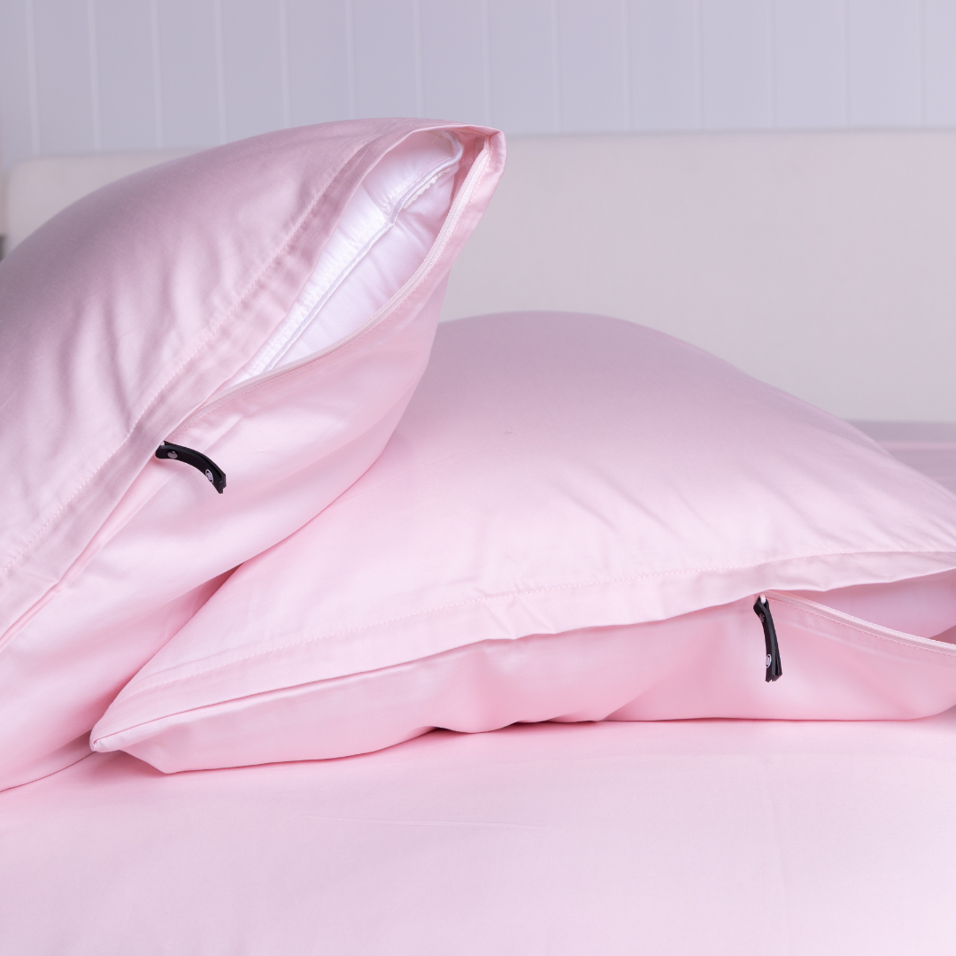 Close-up of The Lad Collective blush pink bamboo cotton blend pillowcases with branded invisible zipper, offering a sleek, secure fit and ultra-soft finish.