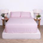The Lad Collective blush pink bamboo cotton blend bedding set neatly made on a modern bed, featuring invisible zip pillowcases and minimalist bedroom styling.