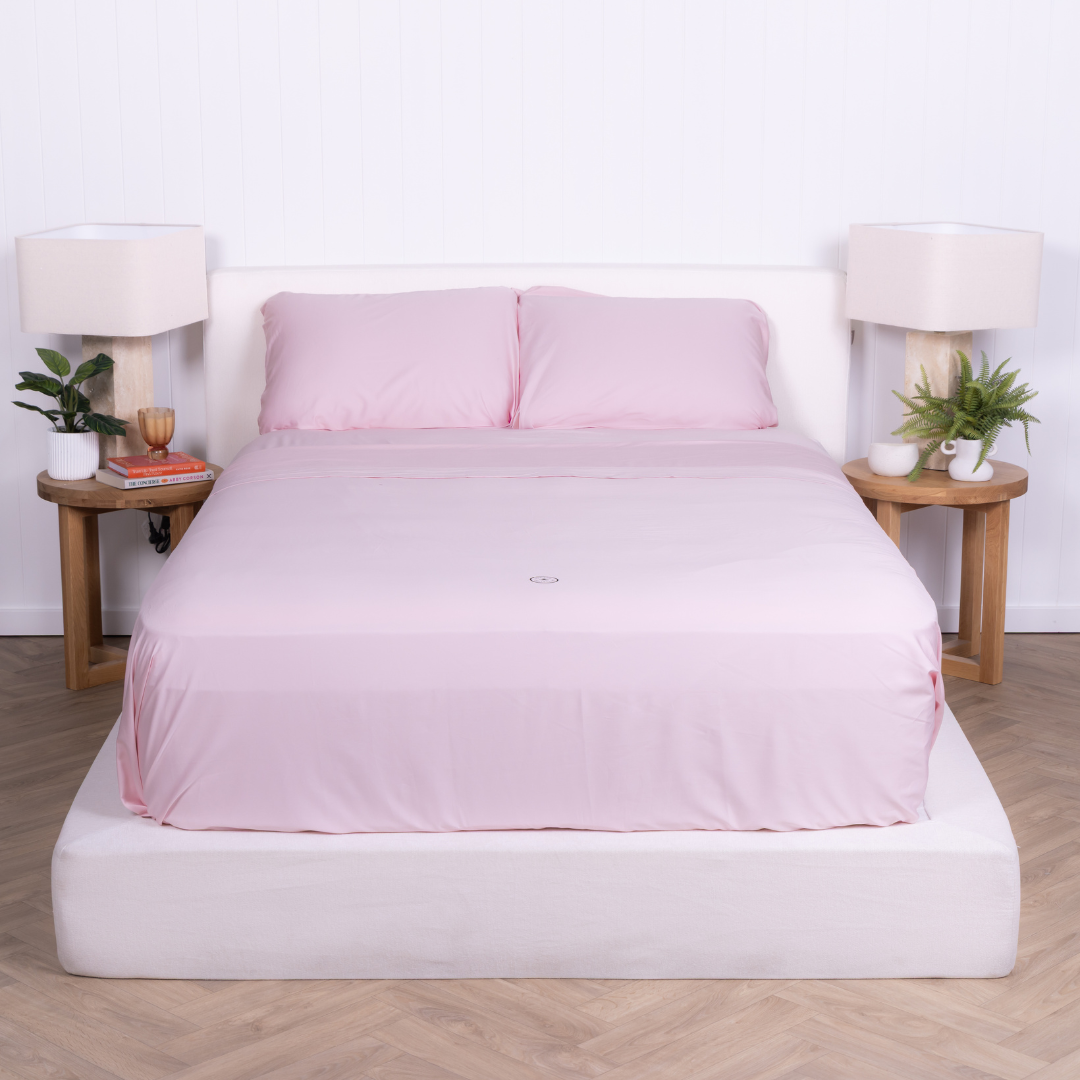 The Lad Collective blush pink bamboo cotton blend bedding set neatly made on a modern bed, featuring invisible zip pillowcases and minimalist bedroom styling.