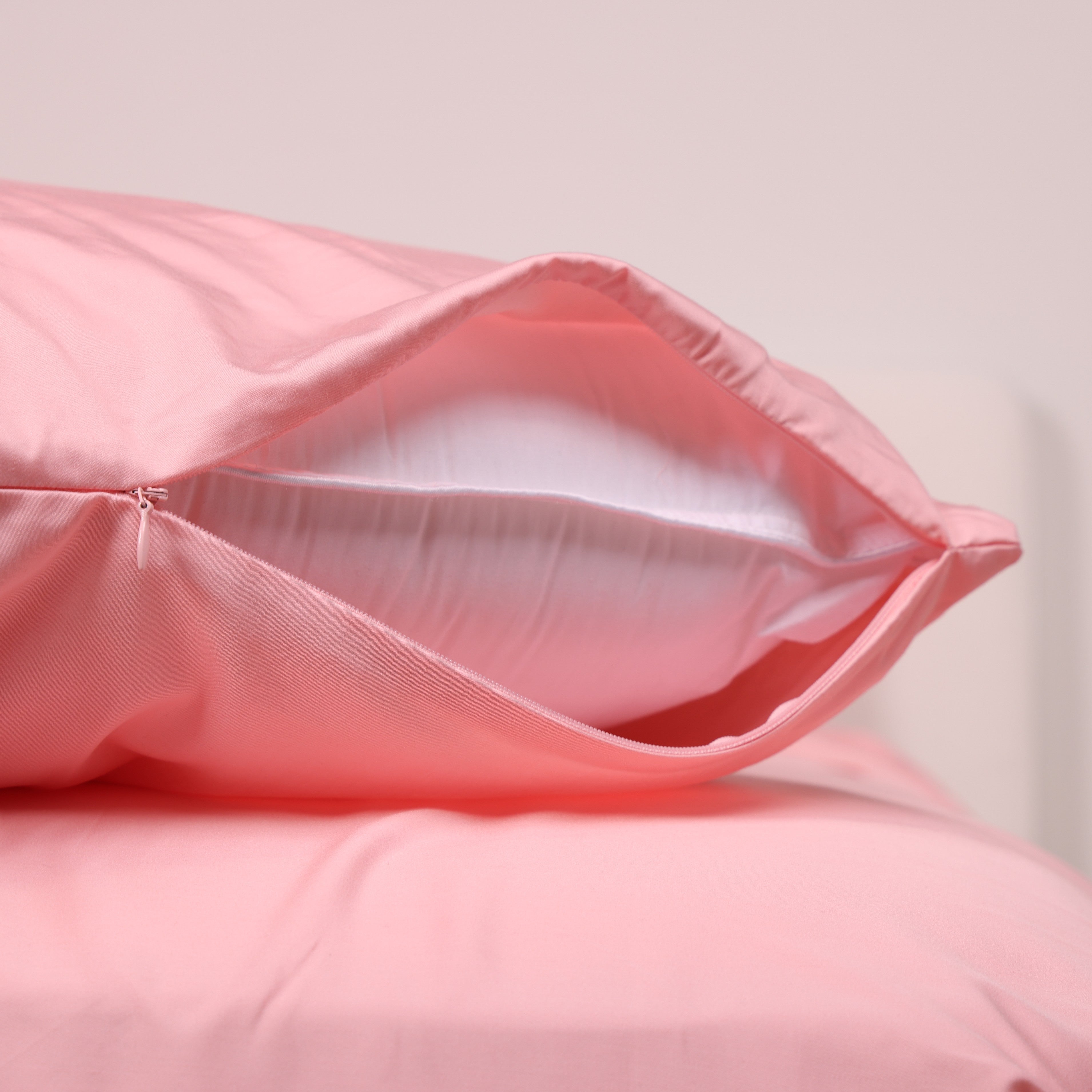 Close-up of The Lad Collective peachy pink bamboo cotton blend pillowcase with invisible zipper, showcasing ultra-soft fabric and smooth, secure pillow closure.