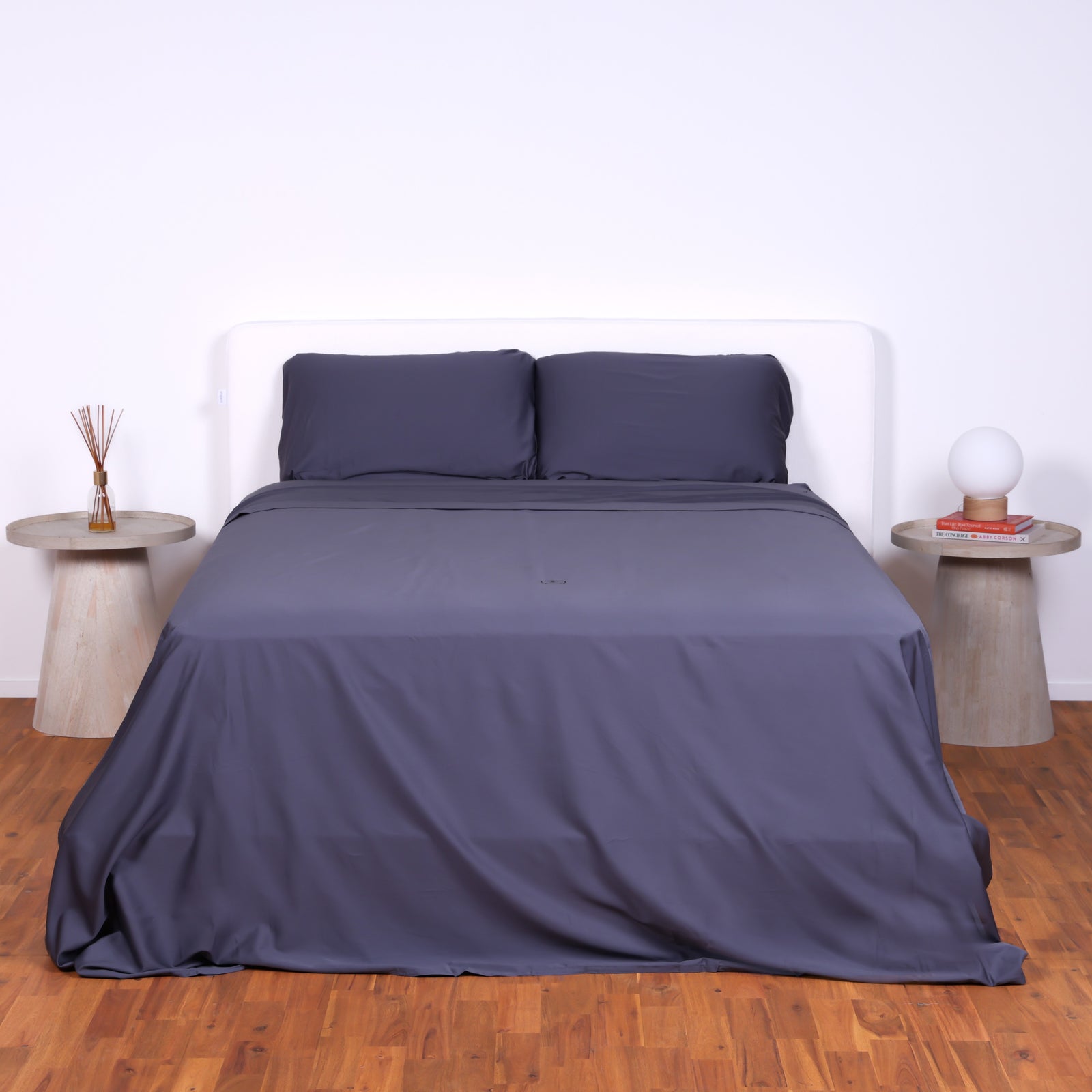 The Lad Collective dark grey bamboo cotton blend bedding set styled on a double bed, featuring fitted sheet, flat sheet, and pillowcases for a soft, breathable, and luxurious sleep setup.