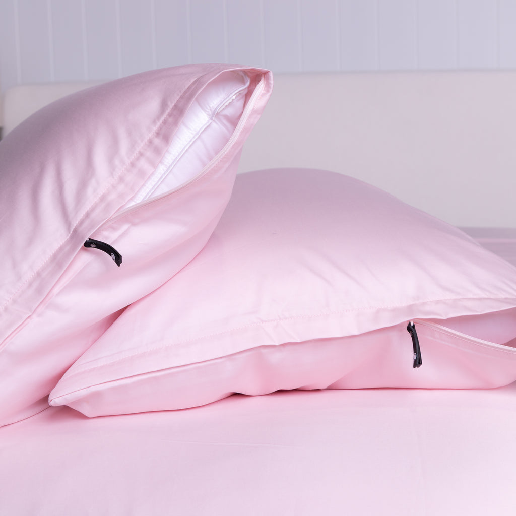 Close-up of The Lad Collective pink bamboo cotton blend pillowcases with invisible zippers, designed for a soft, breathable, and secure fit on your pillows.