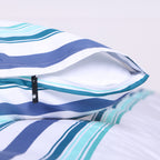 White, blue and teal striped pillowcase with hidden zipper closure, shown on matching duvet cover.