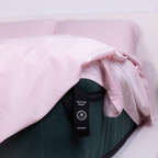 The Lad Collective blush pink bamboo cotton blend fitted sheet with visible “Bottom Right” double size label tag, demonstrating easy bed-making and directional corner identification.