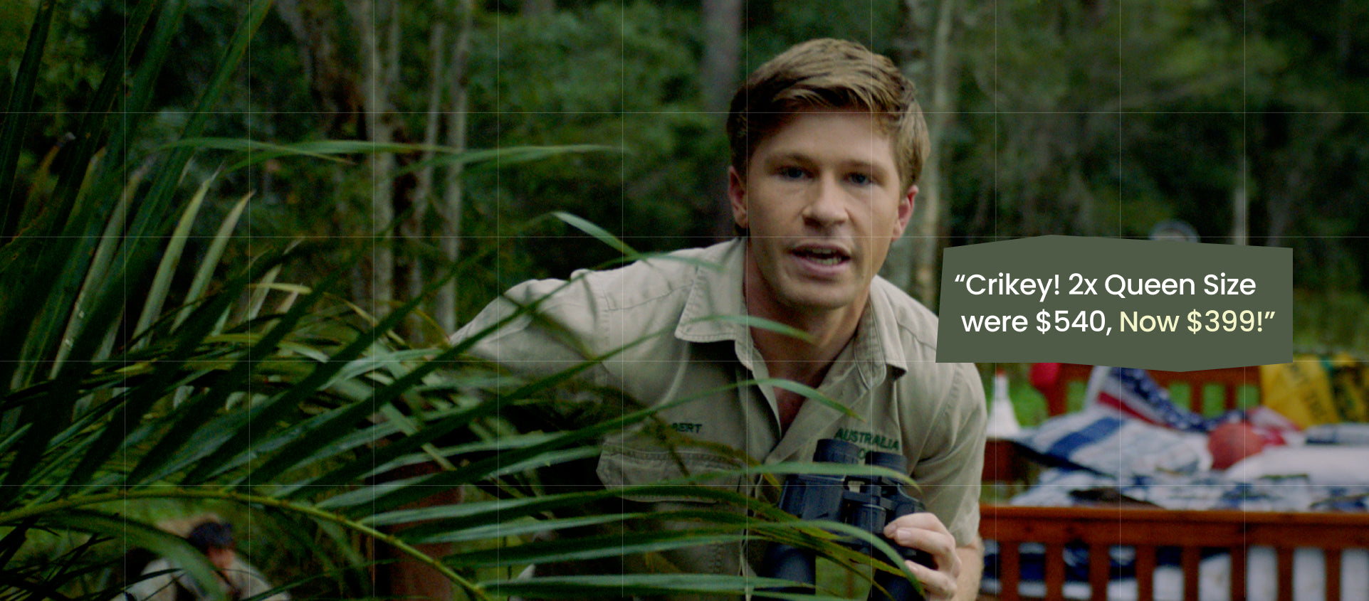 A man in a khaki shirt holding binoculars behind green foliage, with a text overlay that reads: 'Crikey! 2x Queen Size were $540, Now $399!' on a forest background.