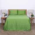 Full view of bed styled in green TLC Colorado sheets with bedside tables.