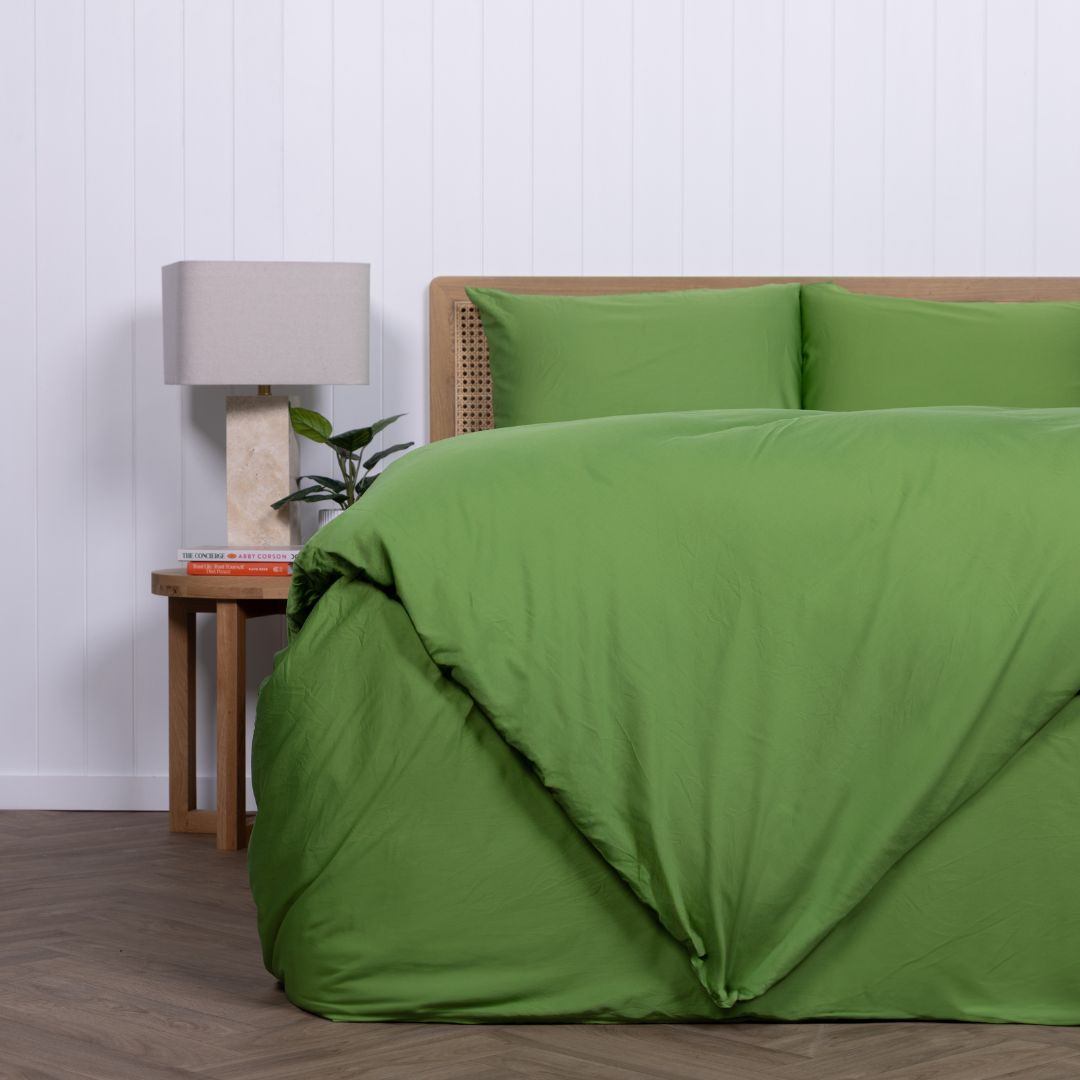 Colorado green duvet cover folded at the foot of the bed with crisp styling.