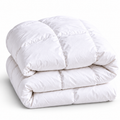 White, fluffy duvet folded together on white background