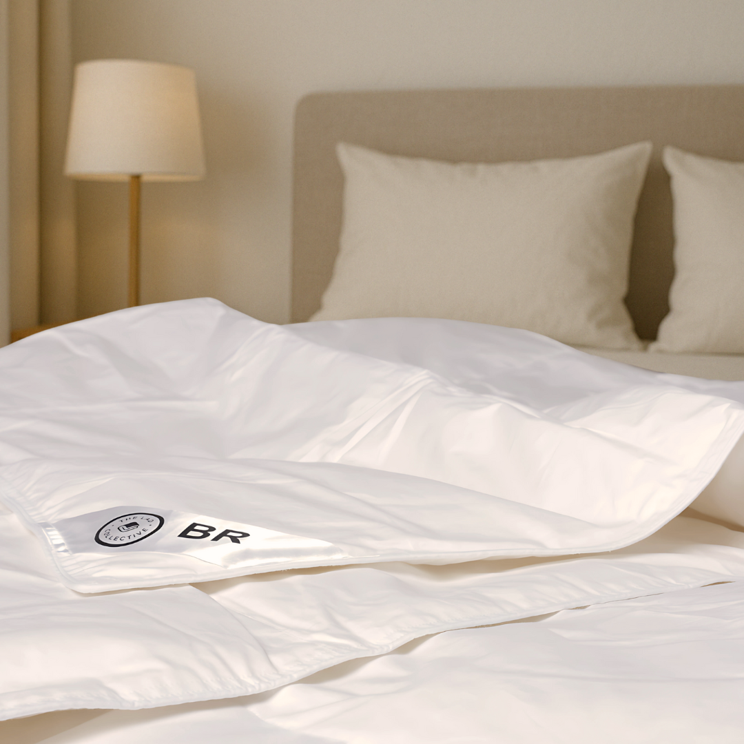 White comforter insert with BR corner label from The Lad Collective, styled on bed with neutral bedding.