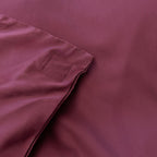 Burgundy colour Quilt Cover with magentic buttons on bed with burgundy Background 