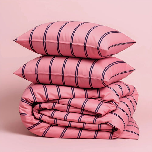 Pink striped bedding set with two pillows on a pink background.