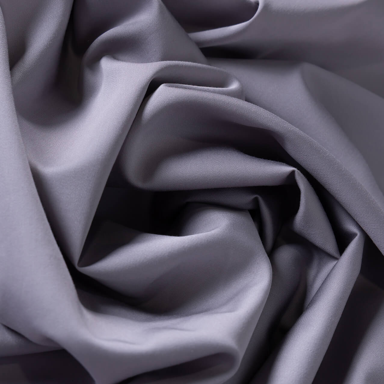 Close-up of slate gray bamboo-cotton fabric with folds.