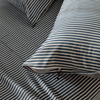 Navy and white pinstripe invisible zip pillowcases.