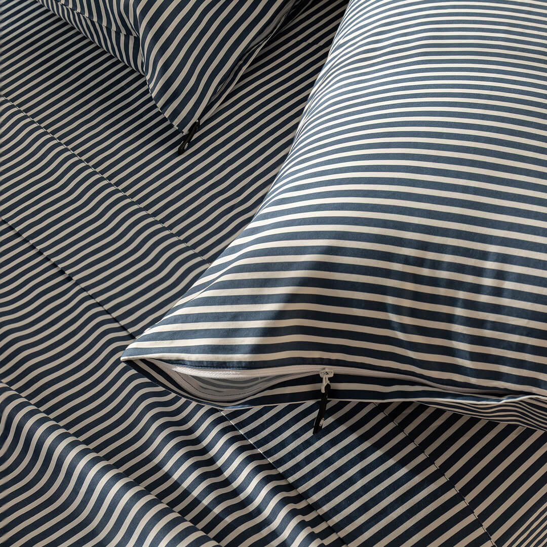 Navy and white pinstripe invisible zip pillowcases.