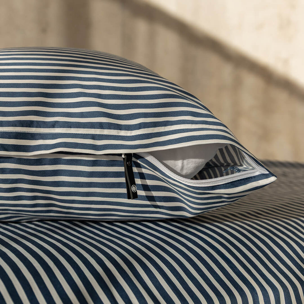 Navy and white pinstripe invisible zip pillowcase close up of zipper.