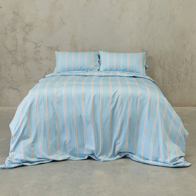 Lake Austin blue and cream striped duvet cover on a bed