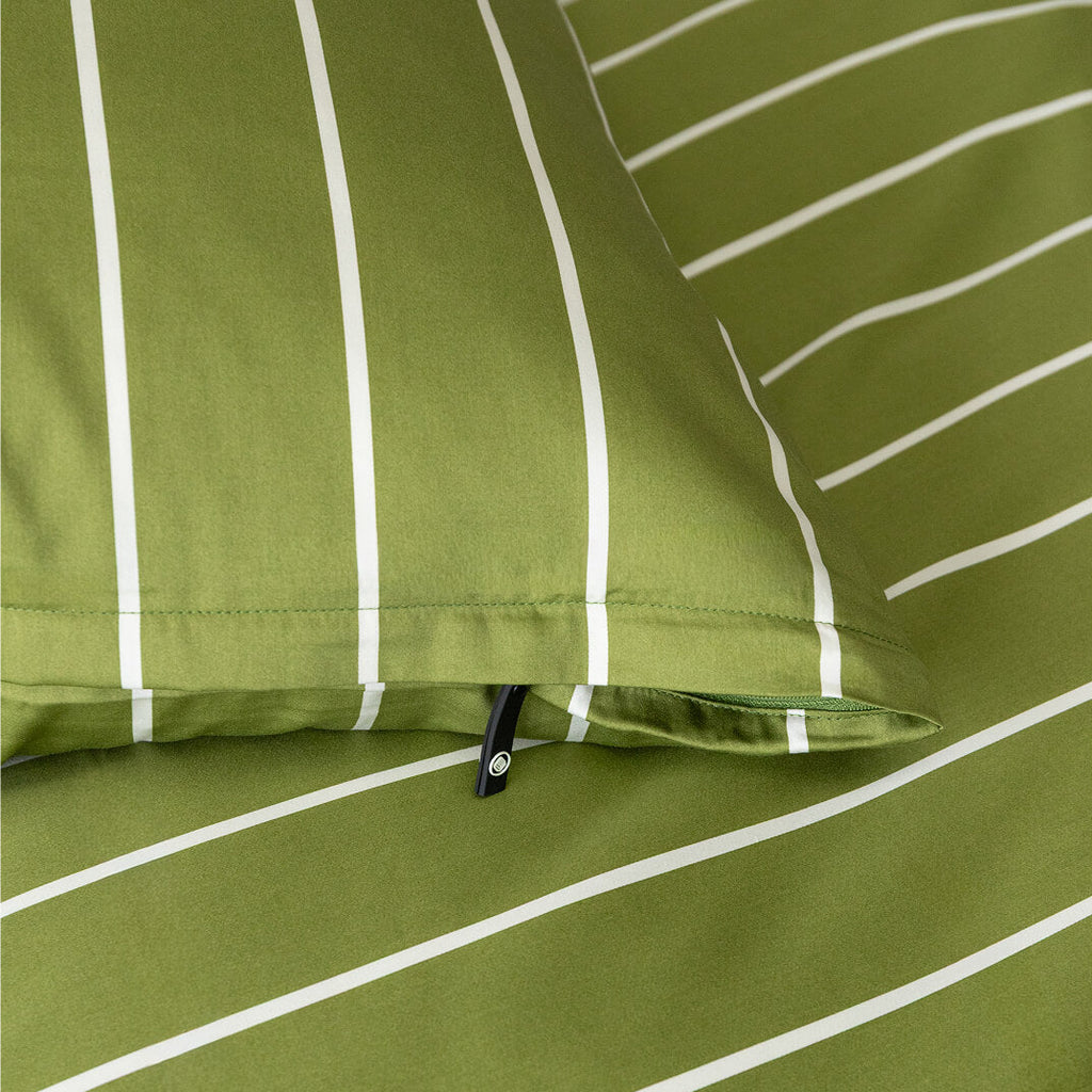 Close-up of green fabric with white stripes and a zipper.