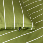 Close-up of green fabric with white stripes and a zipper.