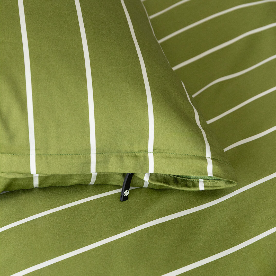 Close-up of green fabric with white stripes and a zipper.