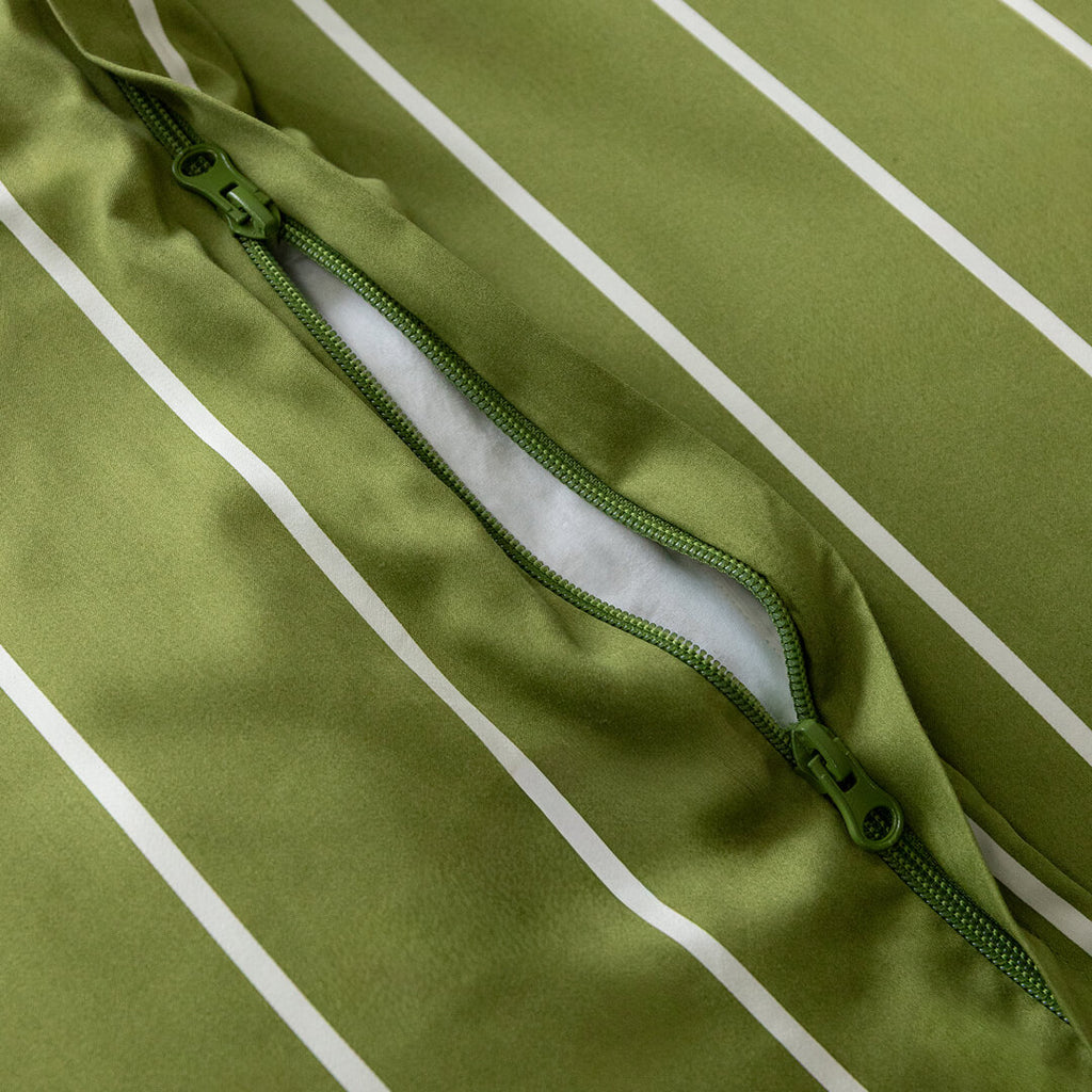 Close-up of a green jacket with a zipper on a green background