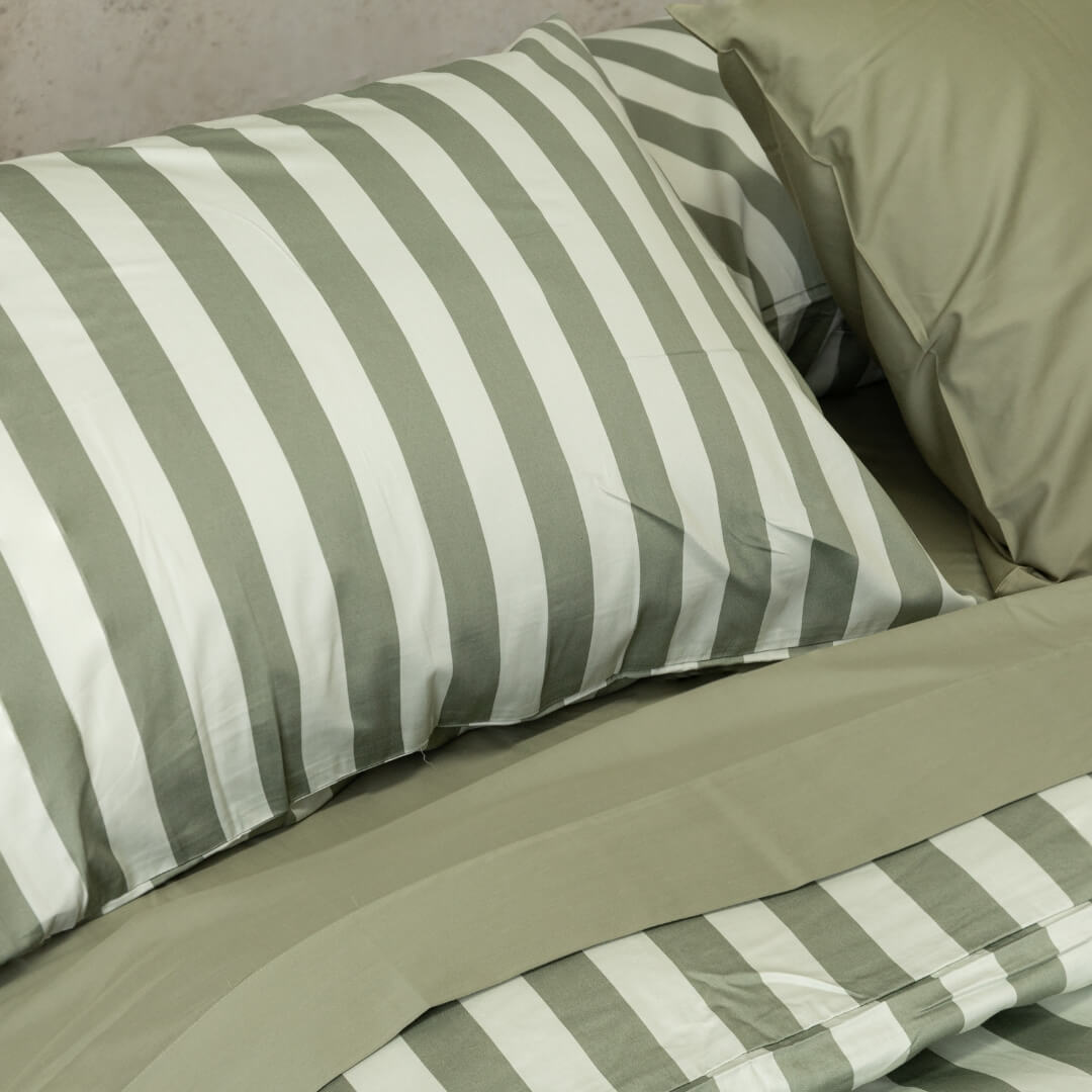 Sage green stripe pillowcase on pillow.