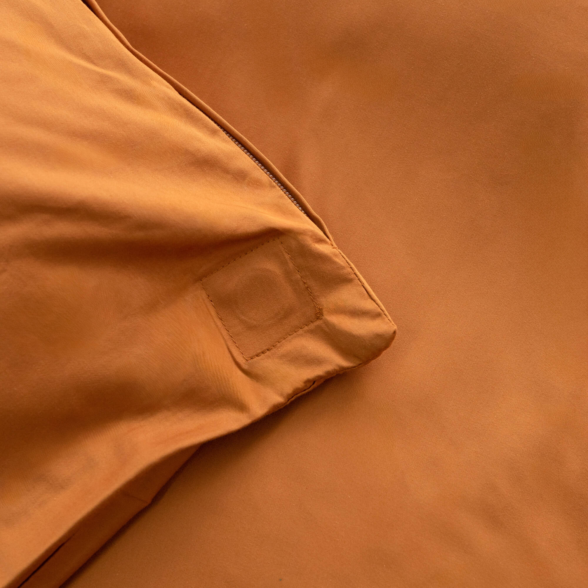 Close up of the burnt orange duvet cover magnetic corner. 