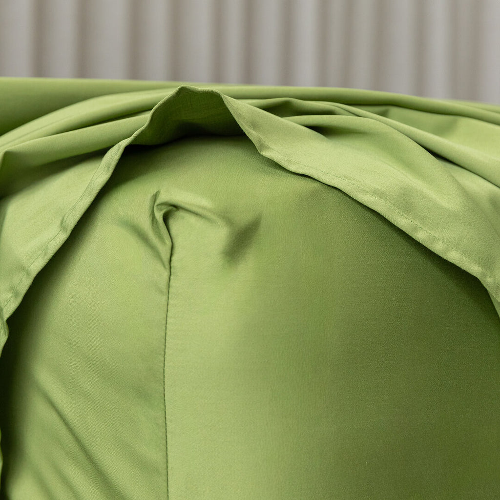 Close-up of green bedding with a neutral background