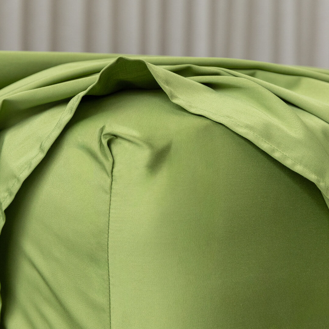 Close-up of green bedding with a neutral background