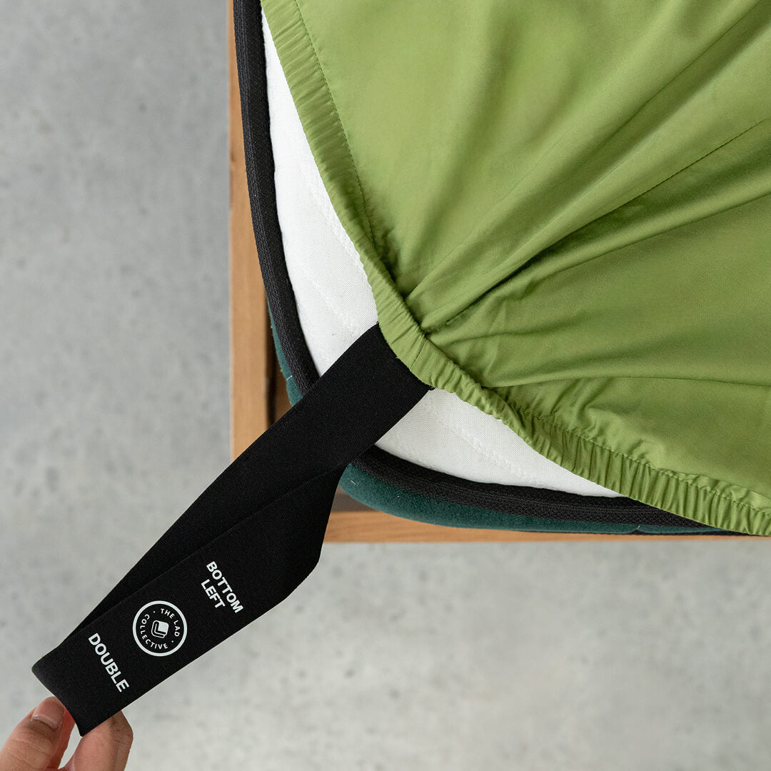 Green chair with a black strap and visible brand logo on a gray background