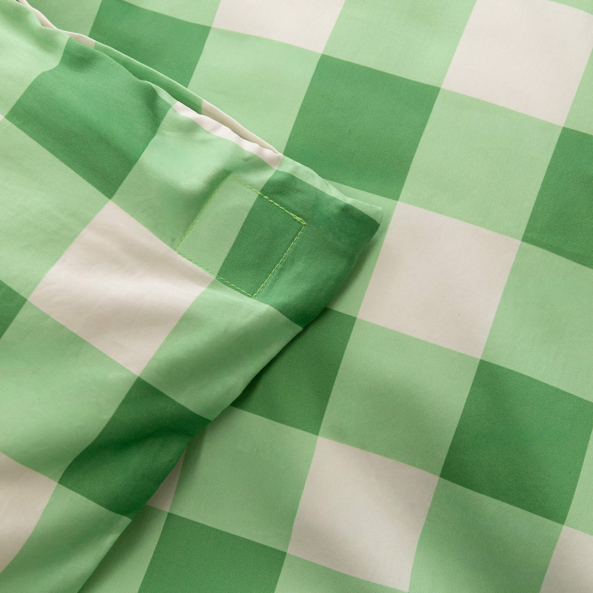 Meadow green gingham print duvet cover magnetic corner close up.