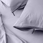 Close up of pillows and pillowcases with zip detail in gray bedding