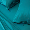 Close up of pillows and pillowcases with zip detail in teal bedding