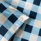 Blue and white checkered duvet cover corner, showcasing the magnetic corner button.