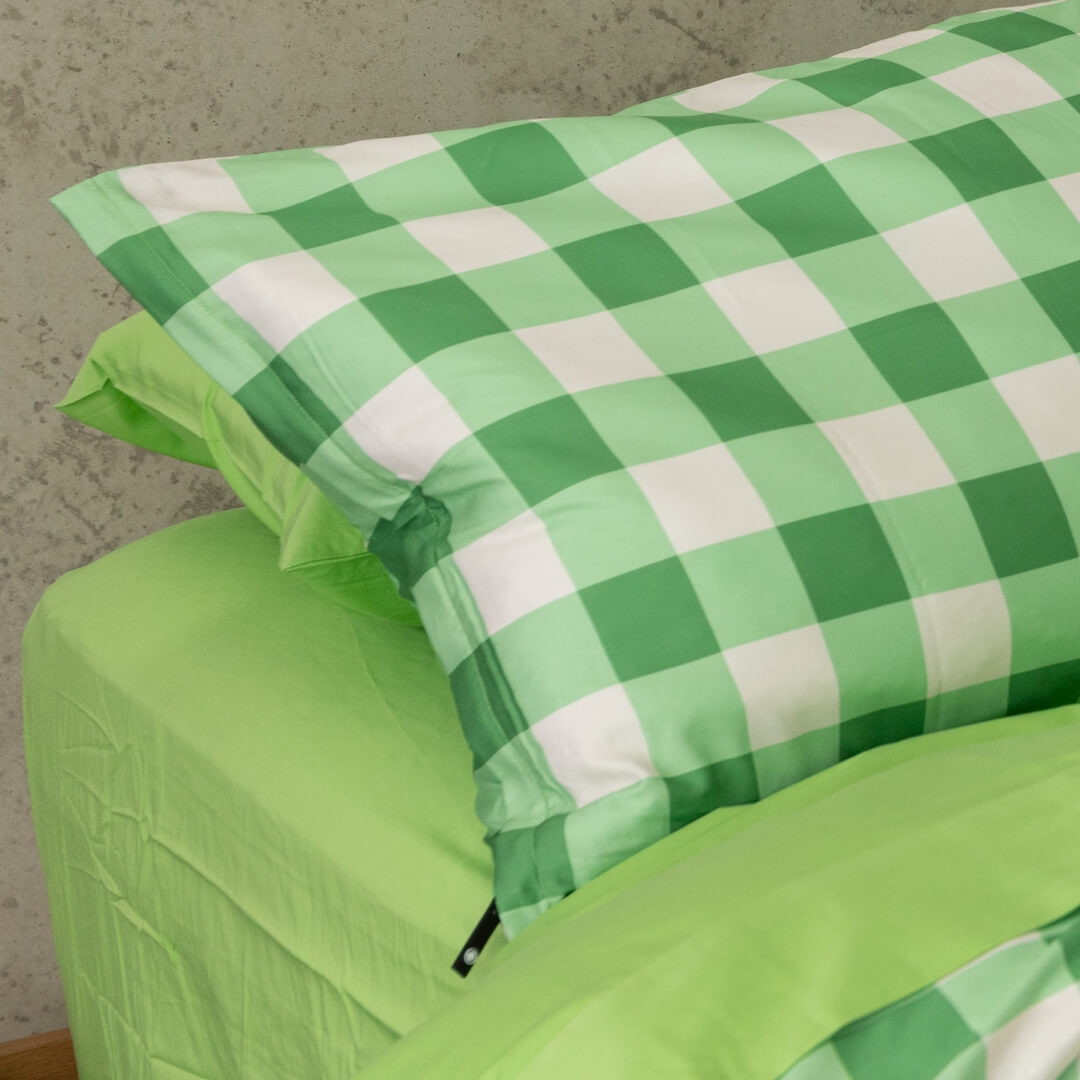 Meadow green gingham print invisible zip pillowcase close up.