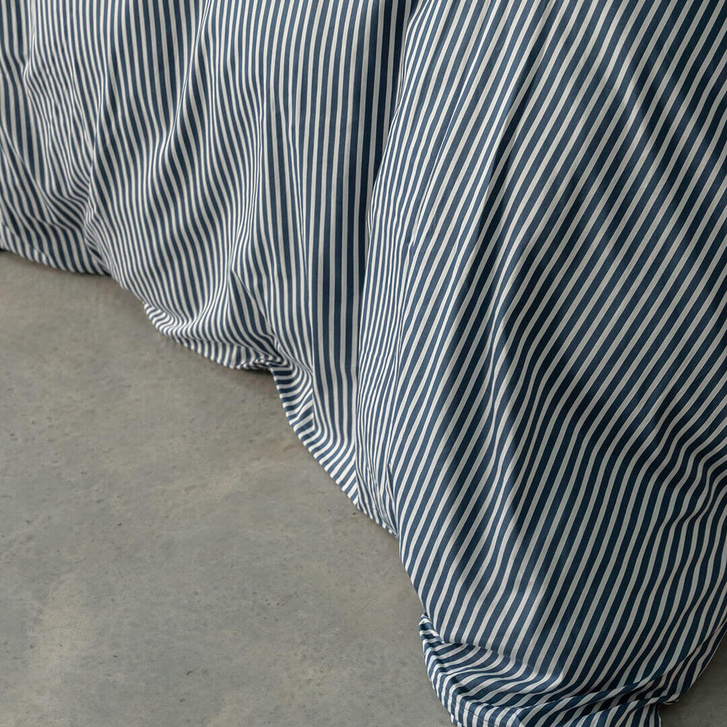 Navy and white pinstripe duvet cover close up.
