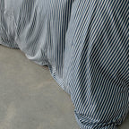 Navy and white pinstripe duvet cover close up.
