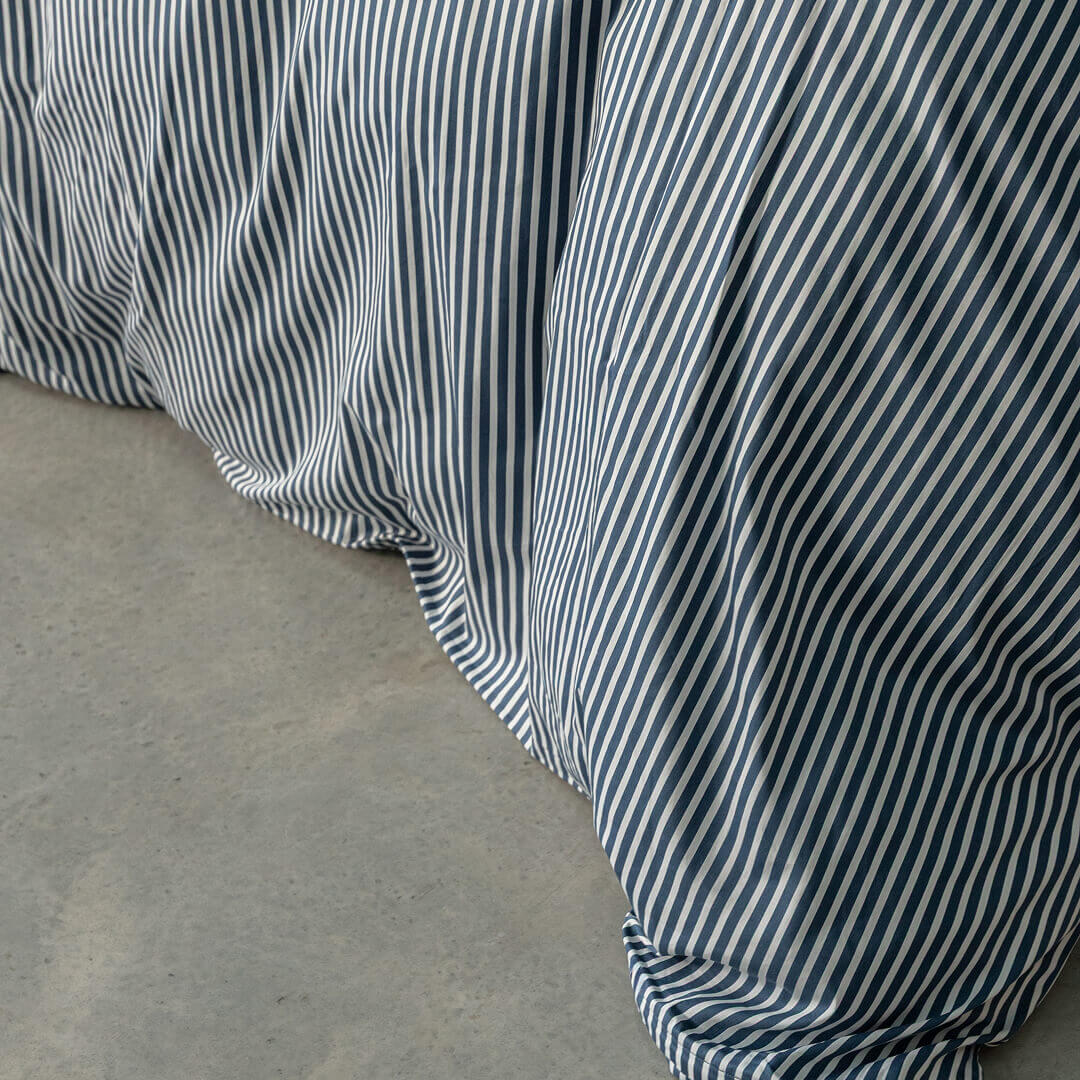 Navy and white pinstripe duvet cover close up.