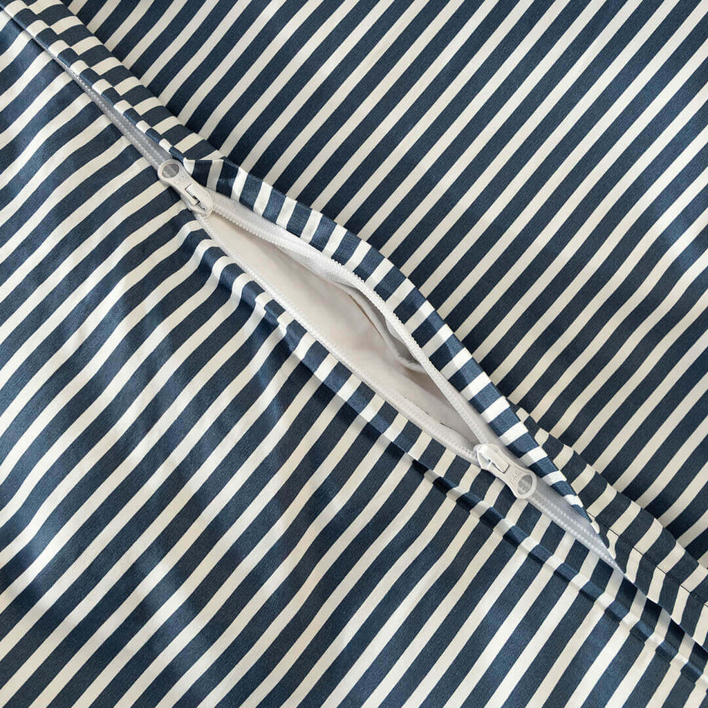 Navy and white pinstripe duvet cover zipper close up.