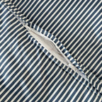Navy and white pinstripe duvet cover zipper close up.