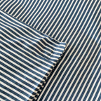 Navy and white pinstripe duvet cover magnetic corner close up.