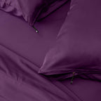 Close-up of purple bedding with a zipper detail on pillowcases.