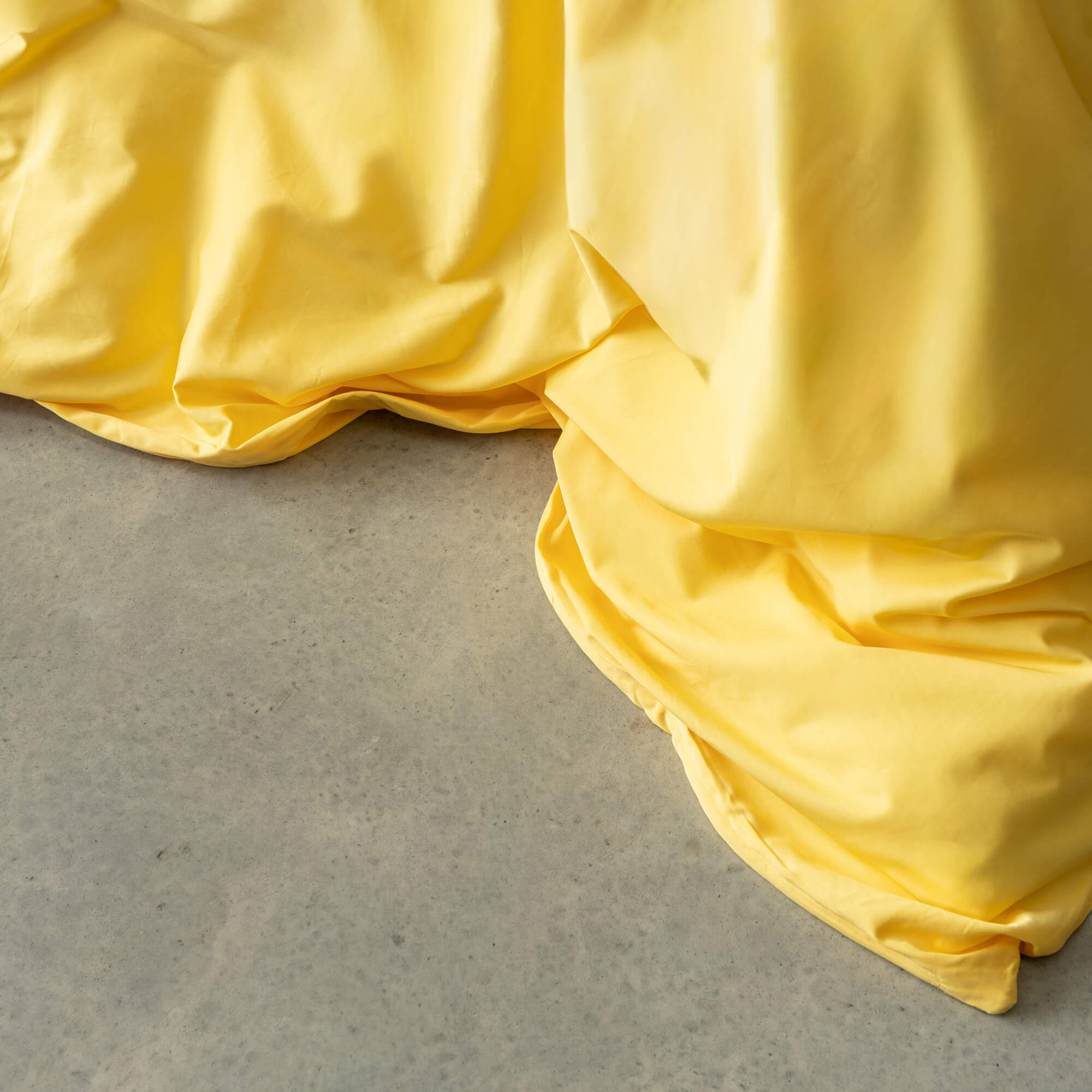 Close-up of a bright yellow duvet cover.
