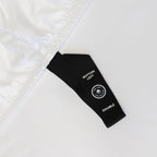 Close-up of a black label on white fabric,  indicating bed sheet size 