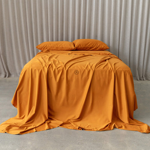 Flame Orange bedding with curtain background.
