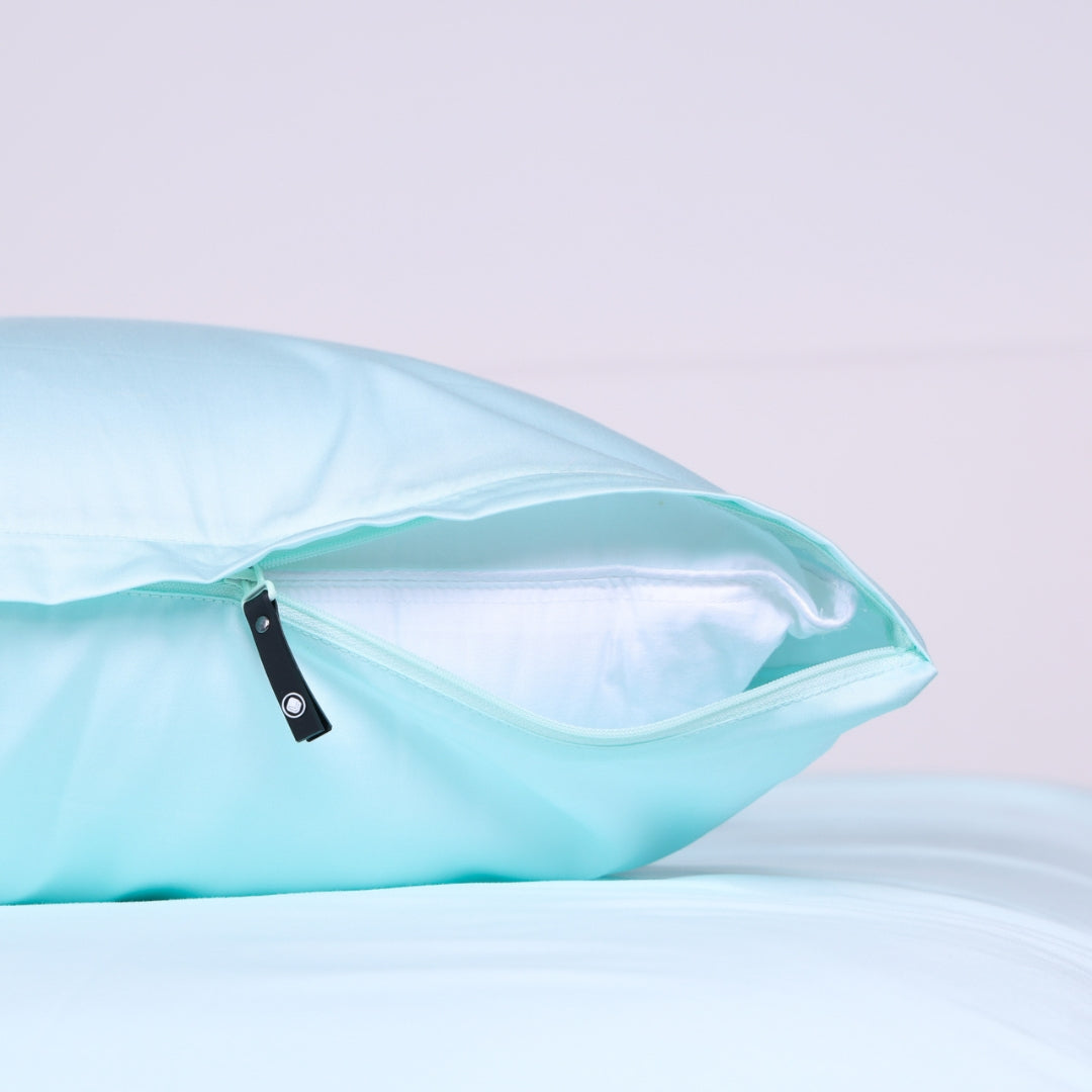 Invisible zipper feature on Riviera Blue pillowcase partially opened to reveal inner pillow.