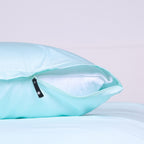 Invisible zipper feature on Riviera Blue pillowcase partially opened to reveal inner pillow.