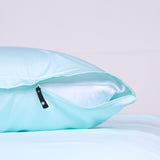 Invisible zipper feature on Riviera Blue pillowcase partially opened to reveal inner pillow.